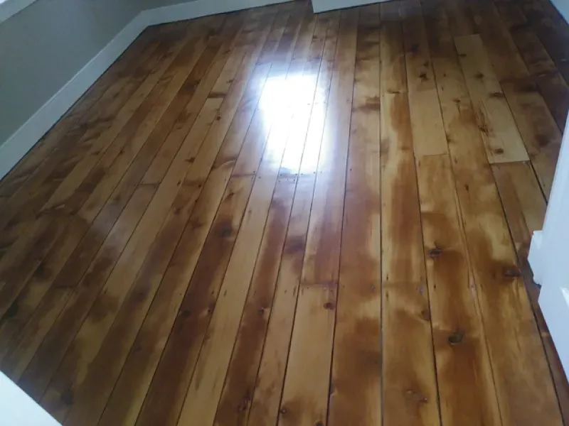 A room with a wooden floor and a window