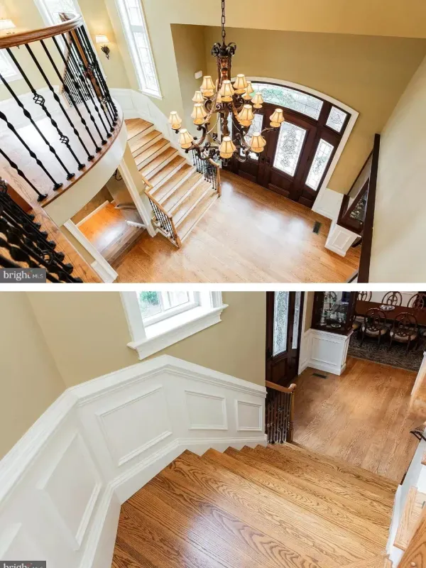 A staircase in a house with a chandelier hanging from the ceiling