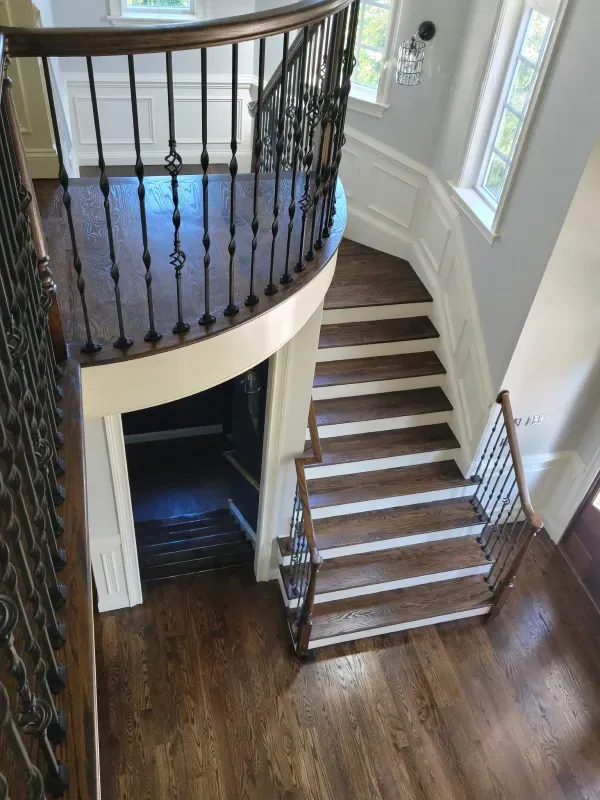 An aerial view of a curved staircase in a house.