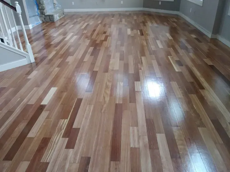 A living room with a wooden floor and stairs