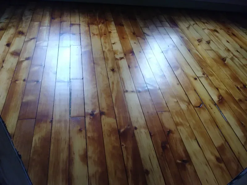 A close up of a wooden floor in a room.